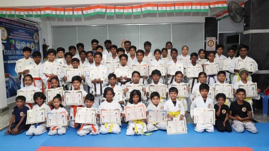 Students holding certificates at belt grading